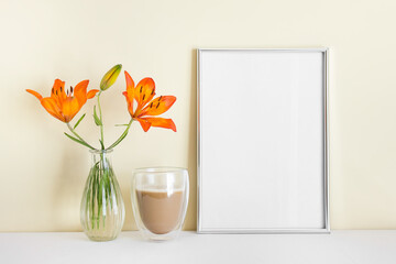 A4 blank silver frame with blank empty space surface, orange lily, morning coffee.