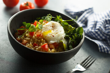 Bulgur with tomato and poached egg