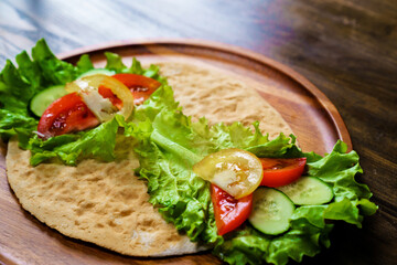 pita with vegetables. simple and delicious snack of flatbread