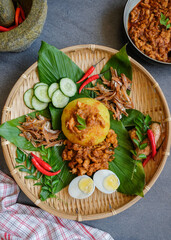 Traditional Malaysian Peranakan cuisine / Nasi Kunyit aka Turmeric Glutinous Rice / Delicious dish eaten with dry curry chicken with glutinous rice cooked in coconut milk and turmeric