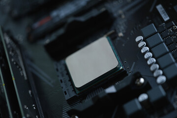 Computer processor in silver is installed in motherboard closeup