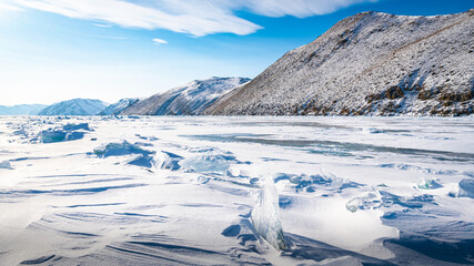 Fototapeta na wymiar Snow-covered hummocks off the coast of Lake Baikal