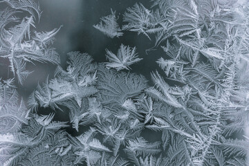 Frosty patterns on a winter window. Cold weather, Christmas mood