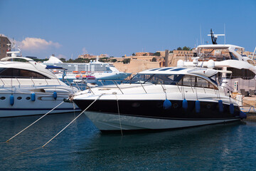 Fototapeta premium Motor yachts moored in marina on a sunny day. Valletta, Malta