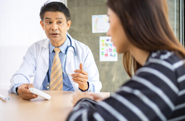 Senior asian doctor encouragement and supportive to cansor patient after consult and examine in clinic hospital health ideas concept. Problem talk at medical checkup visit with wheelchair .