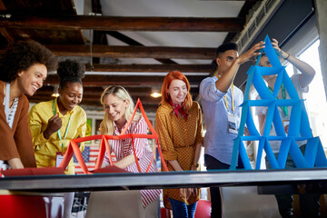 Group of young creative employees are playing games in the office