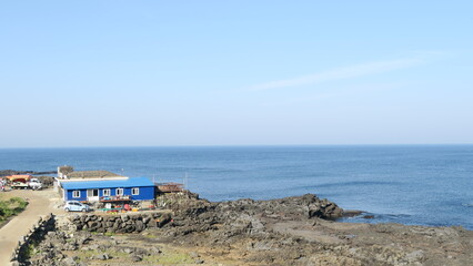 A small blue house near the sea