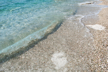 Fototapeta na wymiar Waves on the Beach. Ksamil, Albania