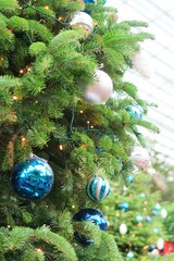 Blue and white Christmas ball decorations hanging on Christmas tree