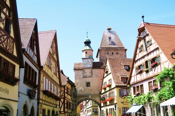 Fototapeta premium The small town Rothenburgob der Tauber with many preserved colorful medieval half timbered houses. This is the entrance tower of the town.