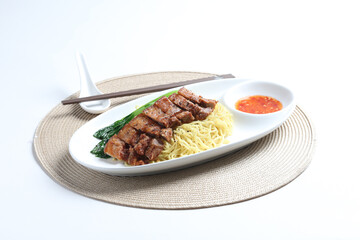 chef cook dry noodle mee with grilled chicken chop, pork cutlet and vegetable in soy sauce and chilli sauce asian halal menu