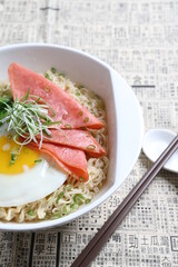 chef cook noodle mee soup with chicken ham and fried egg and vegetable asian halal menu