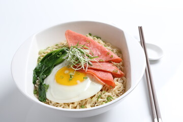 chef cook noodle mee soup with chicken ham and fried egg and vegetable asian halal menu