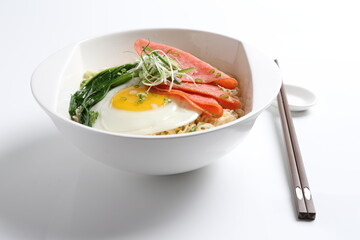 chef cook noodle mee soup with chicken ham and fried egg and vegetable asian halal menu