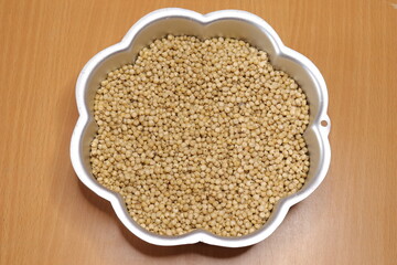 Organic jawar seeds isolated on wood background