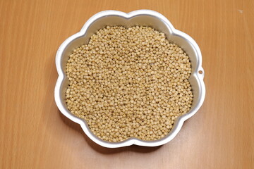 Organic jawar seeds isolated on wood background