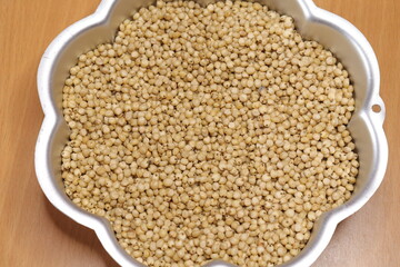 Organic jawar seeds isolated on wood background