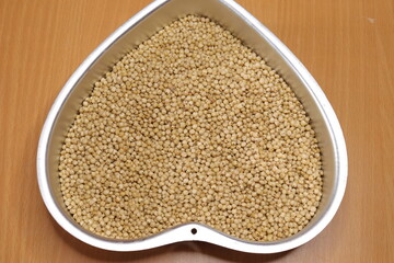 Organic jawar seeds isolated on wood background