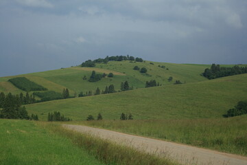 Green hills with dark clouds