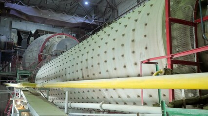 Ball mill inside the cement processing industry. An industrial enterprise for the processing of cement. The territory of the cement plant. Production