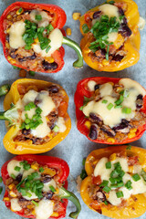 Peppers stuffed with groats and vegetables, sprinkled with cheese. View from above. - 441722524