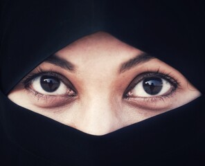 Naklejka premium Closeup of beautiful woman face covered with hijab. Perfect shiny eyes of a Muslim girl. Young niqab girl portrait.
