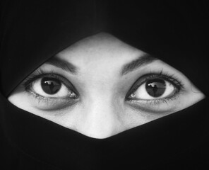 Closeup of beautiful woman face covered with hijab. Perfect shiny eyes of a Muslim girl. Young niqab girl portrait.