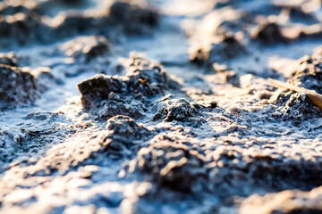 crystals of salt and therapeutic mud close-up. Natural texture of sea salt and therapeutic mud at the balneological resort. treatment of diseases of the joints and skin with natural substances