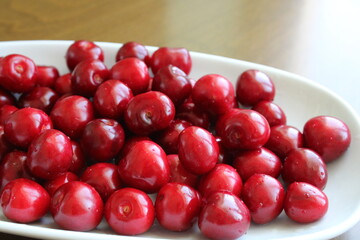  fresh cherry fruits in a bowl on table, summer fruits