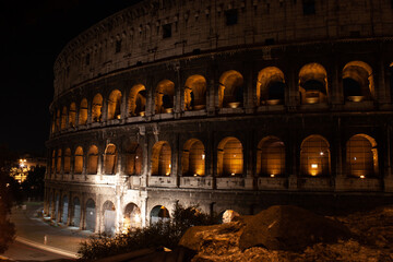 Fototapeta na wymiar Roman Colosseum under the atmospheric cover of darkness at night in Rome, Italy