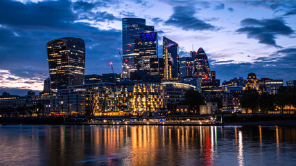 City of London at nighttime sunset with iconic London buildings such as Walkie Talkie, The Gherkin, The Cheese-grater and more. 