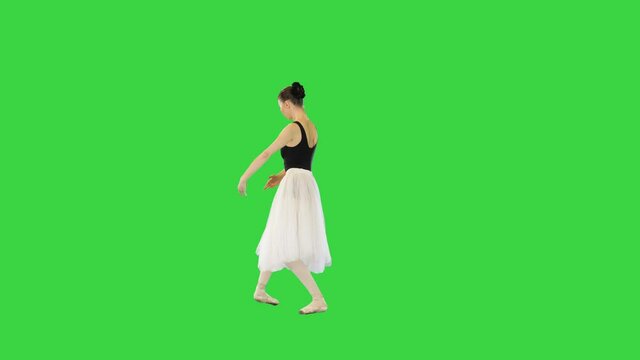 Young ballerina performing basic movements on a Green Screen, Chroma Key.