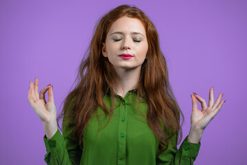 Calm woman relaxing, meditating. She calms down, breathes deeply with mudra om on violet studio...