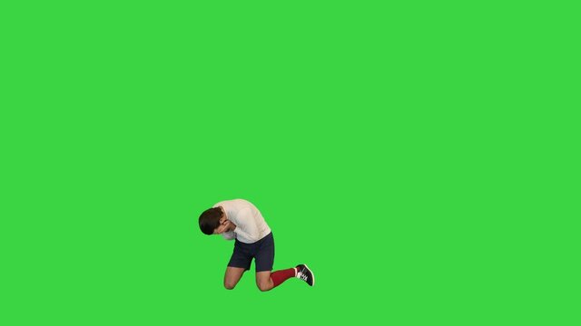 Soccer payer failing to goal and covering his face with his hands on a Green Screen, Chroma Key.