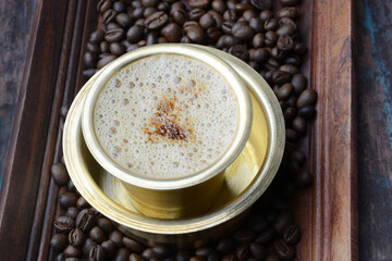 Filter coffee served in a brass cup.