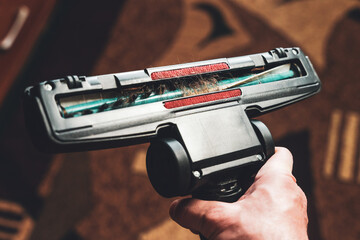 Cleaning the room, long hair wrapped around a vacuum cleaner's turbo brush