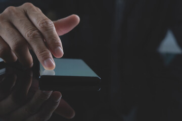 Close up of man finger using and touching on mobile phone screen