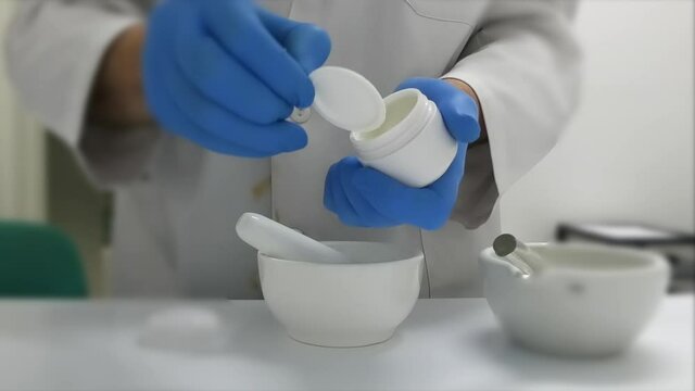 Opening an ointment jar in the prescription lab. Selective focus