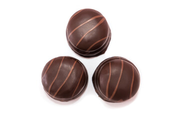 three chocolate candies isolated on white background.