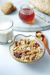  cereal breakfast in bowl, honey and milk on white background 