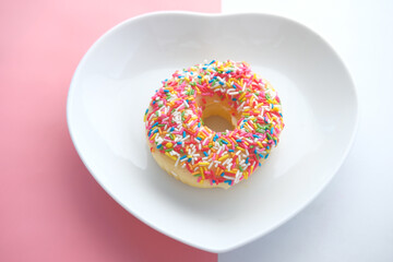 colorful donuts on heart shape plate 