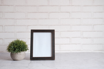  empty frame on table against white wall 