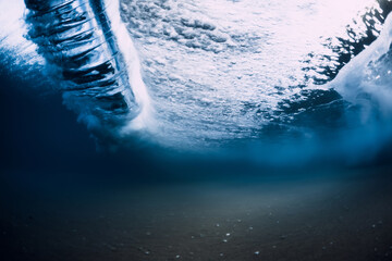 Ocean wave and vortex underwater with crystal water.