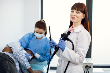Endoscopy concept. Portrait of young Caucasian woman doctor holding endoscope before endoscopy....