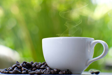 Coffee cup and coffee beans on table, americano coffee in coffee shop, copy space for text, close up white cup on counter