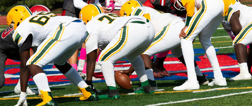 Football Players Lined Up Ready To Start A Play During A Game