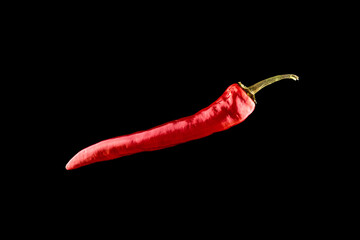 Pepper chili. Red hot chili paprika or spicy chile cayenne pepper isolated on black background....