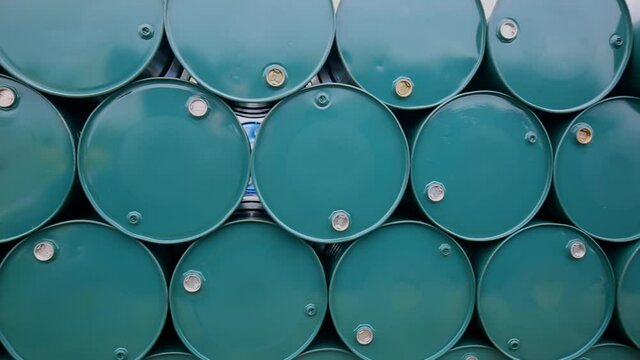 Oil barrels green or chemical drums horizontal stacked up industry.