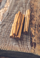 Cinnamon sticks on the wooden background