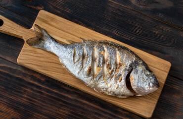 Grilled fish on the wooden board